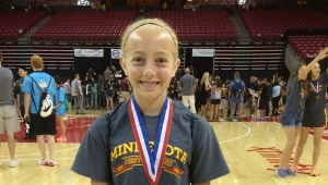 Seventh grader, Mary Jo Dalsin, from New Prague, Minnesota, at the National History Day Competition in Washington, D.C., with her 3rd place medal in the junior individual documentary division for her video on the Japanese American Internment during World War II.  Photo credit:  Emily Dalsin.